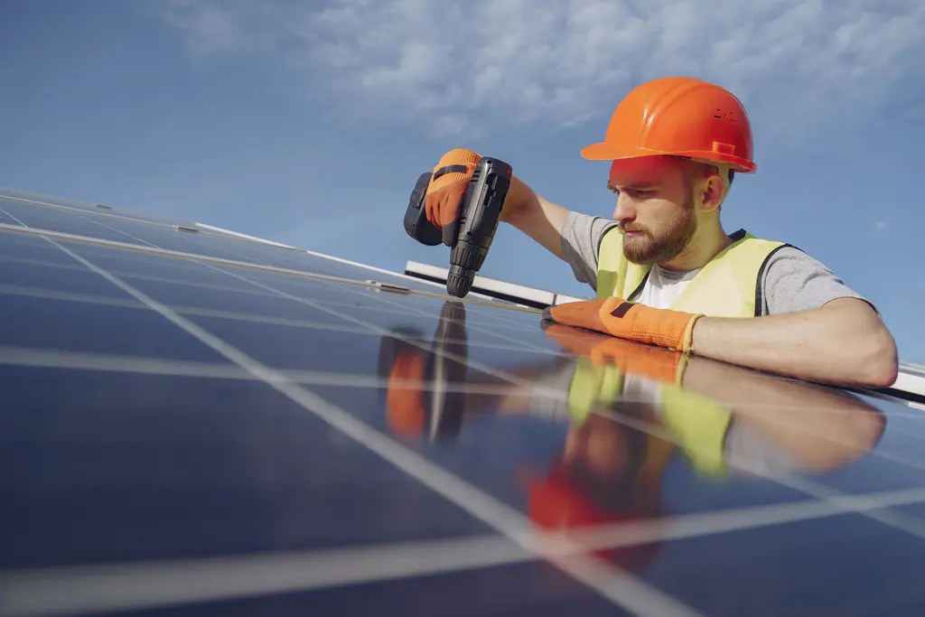 Solar technician installing photovoltaic panels