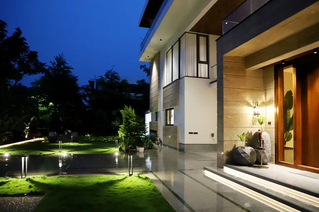 Home and compound illuminated at night by solar flood lights